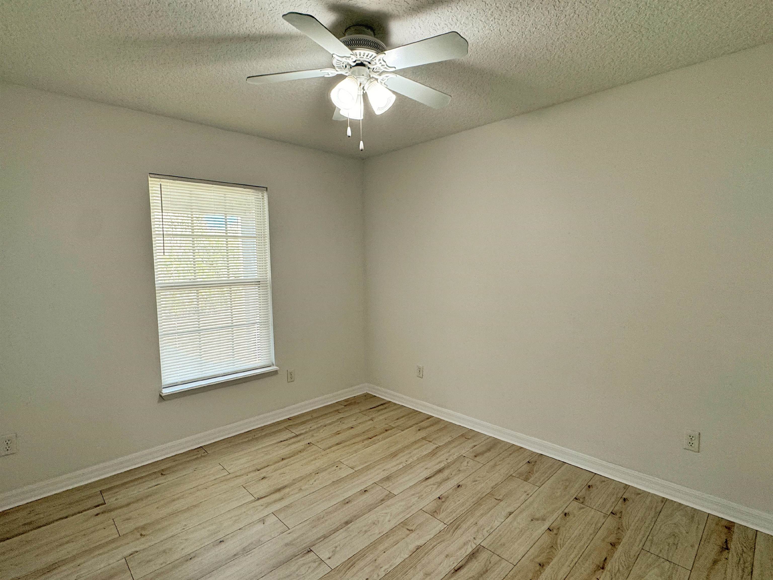 632 Segovia Road St. Augustine, FL 32086 - Photo 20 of 28 an empty room with a window and a fan