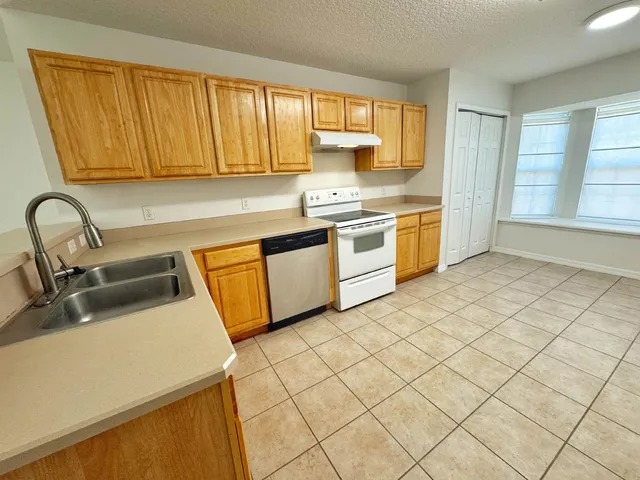 a kitchen with stainless steel appliances granite countertop a sink and cabinets
