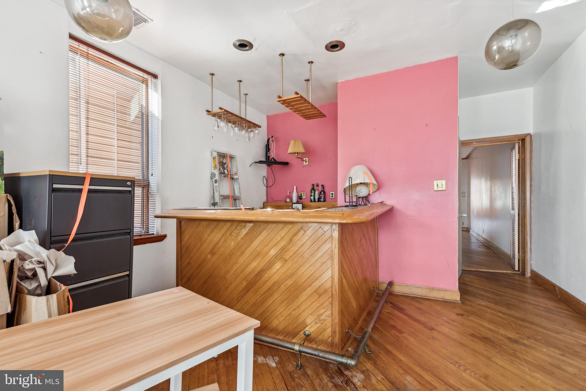 2333 Eutaw Place Baltimore, MD 21217 - Photo 20 of 37 a room with table chairs and wooden floor