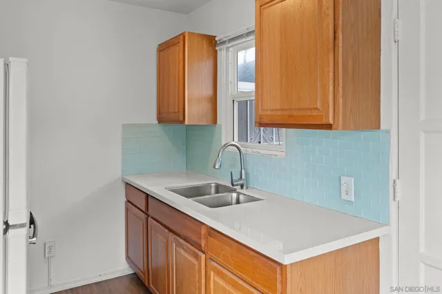 a front view of a house with a yard and potted plants