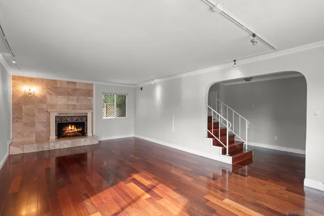 a view of a kitchen with wooden floor and a window