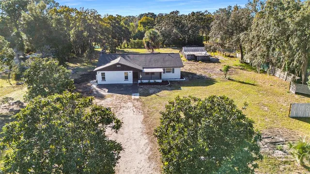 a view of a house with a yard and sitting area