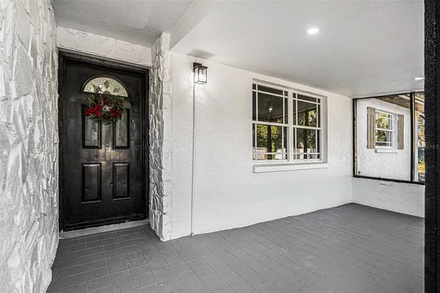 an empty room with windows and entrance