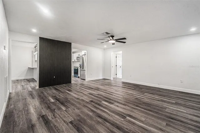 a view of an empty room with wooden floor
