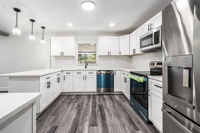 a kitchen with a sink microwave and refrigerator