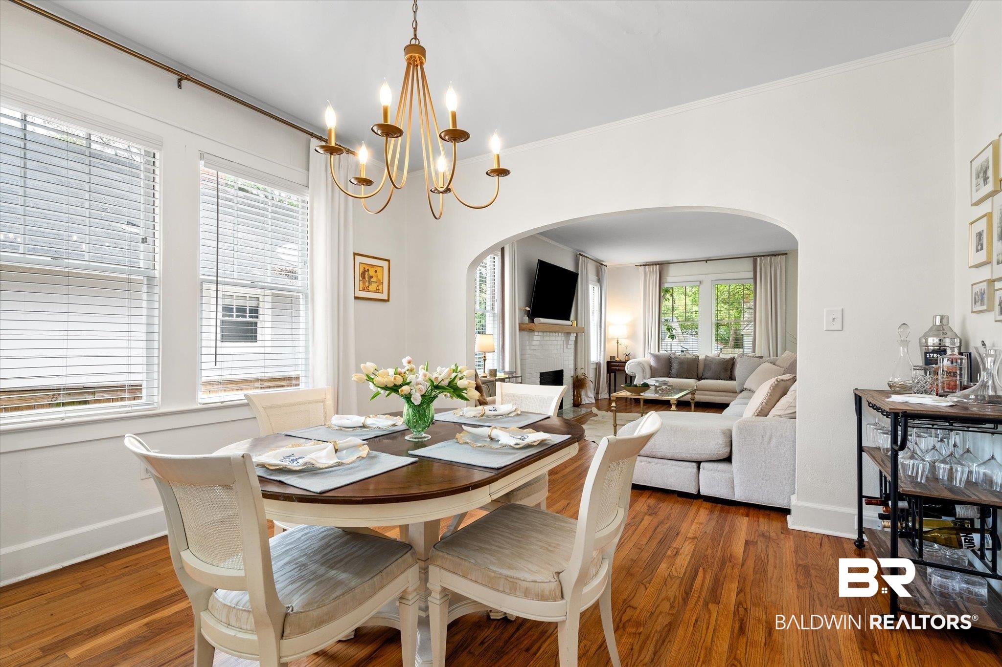 112 Crenshaw Street Mobile, AL 36606 - Photo 7 of 21 Dining area featuring a chandelier, arched walkways, wood finished floors, and crown molding