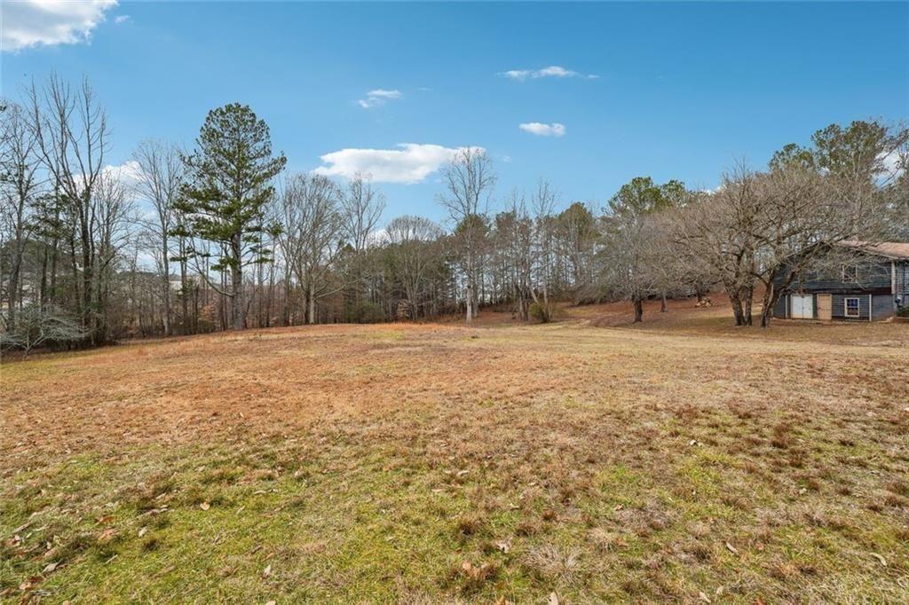8265 Seabolt Drive Ball Ground, GA 30107 - Photo 15 of 52 a swimming pool with trees in the background