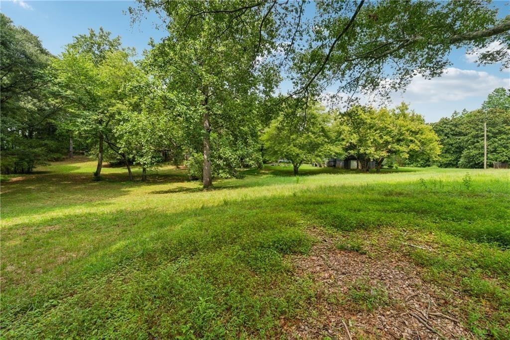 8265 Seabolt Drive Ball Ground, GA 30107 - Photo 3 of 52 a view of a field with trees in the background