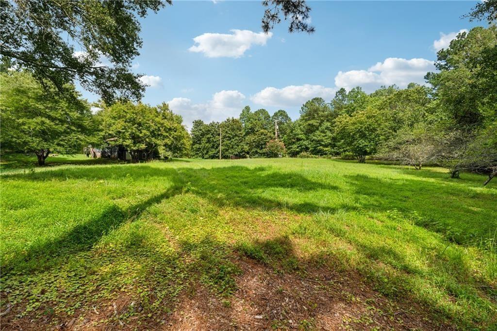 8265 Seabolt Drive Ball Ground, GA 30107 - Photo 6 of 52 a view of a big yard with plants and large trees