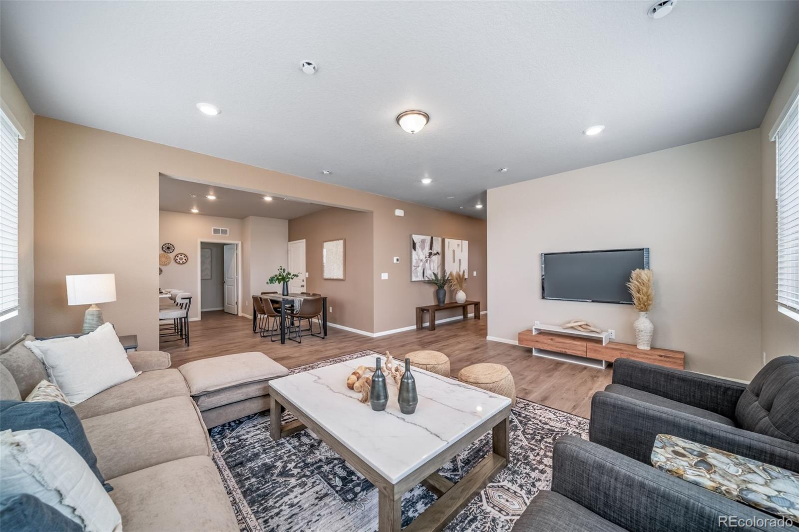 10155 Scranton Way Commerce City, CO 80022 - Photo 11 of 28 a living room with furniture and wooden floor