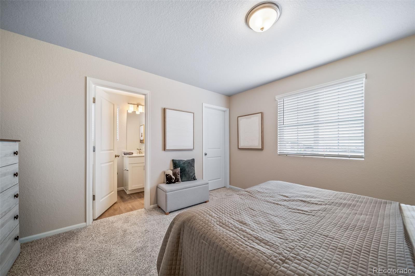 10155 Scranton Way Commerce City, CO 80022 - Photo 18 of 28 a bedroom with a bed and a window