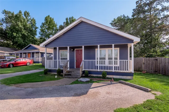 a view of backyard with deck and garden