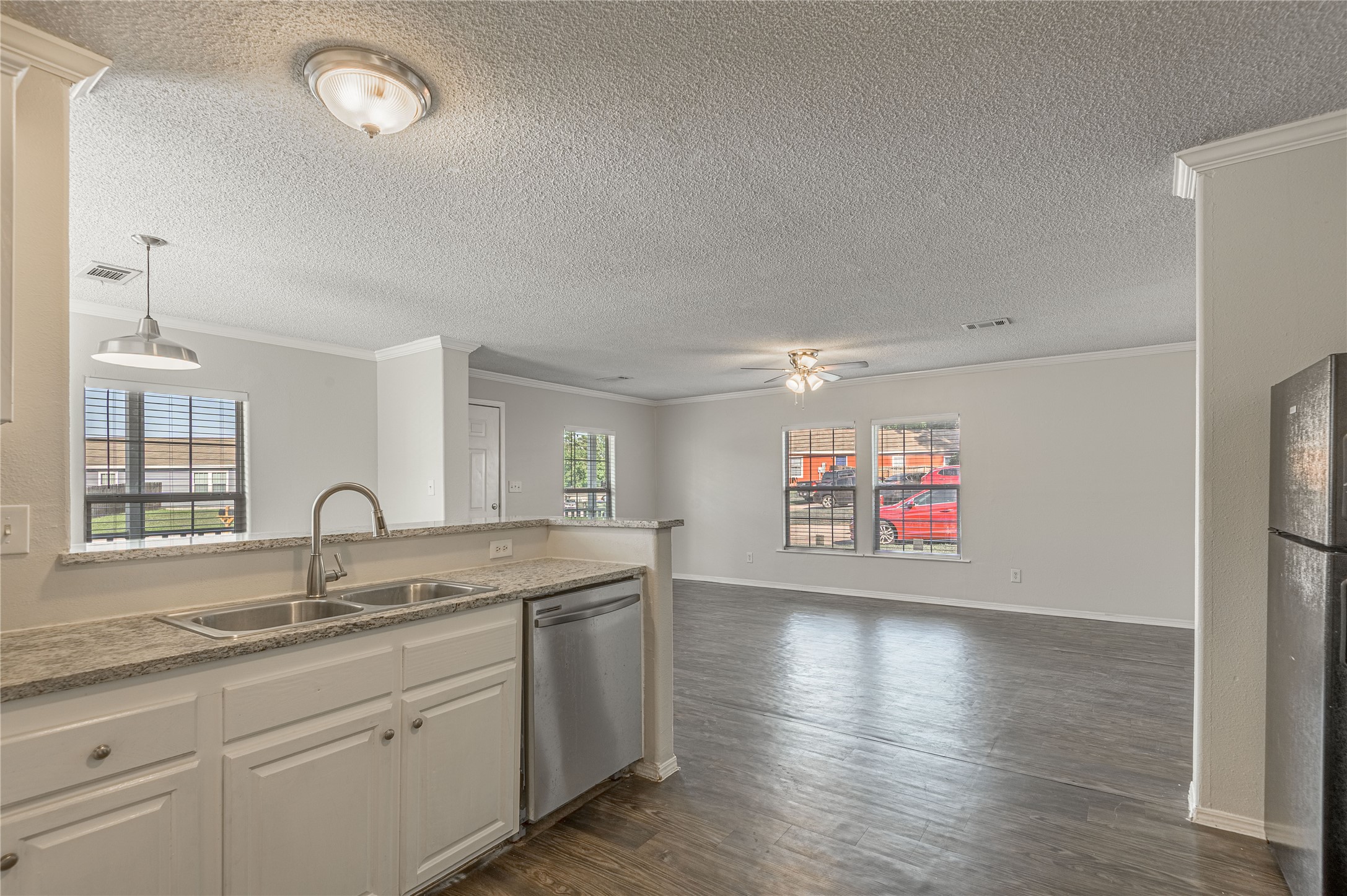 138 Varsity Circle Huntsville, TX 77340 - Photo 12 of 37 a kitchen with granite countertop a sink and a stove