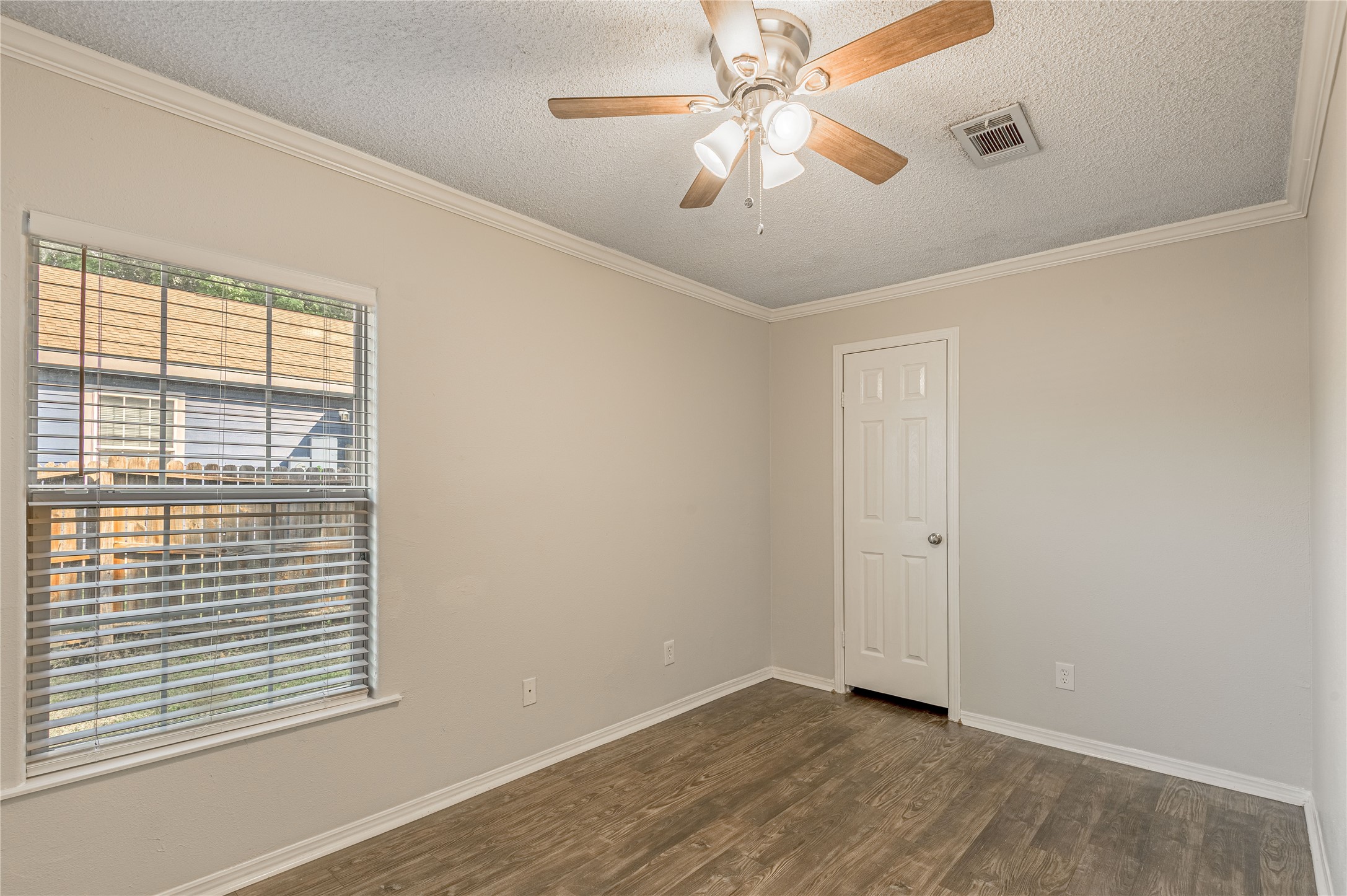 138 Varsity Circle Huntsville, TX 77340 - Photo 15 of 37 a view of an empty room with a window and a ceiling fan