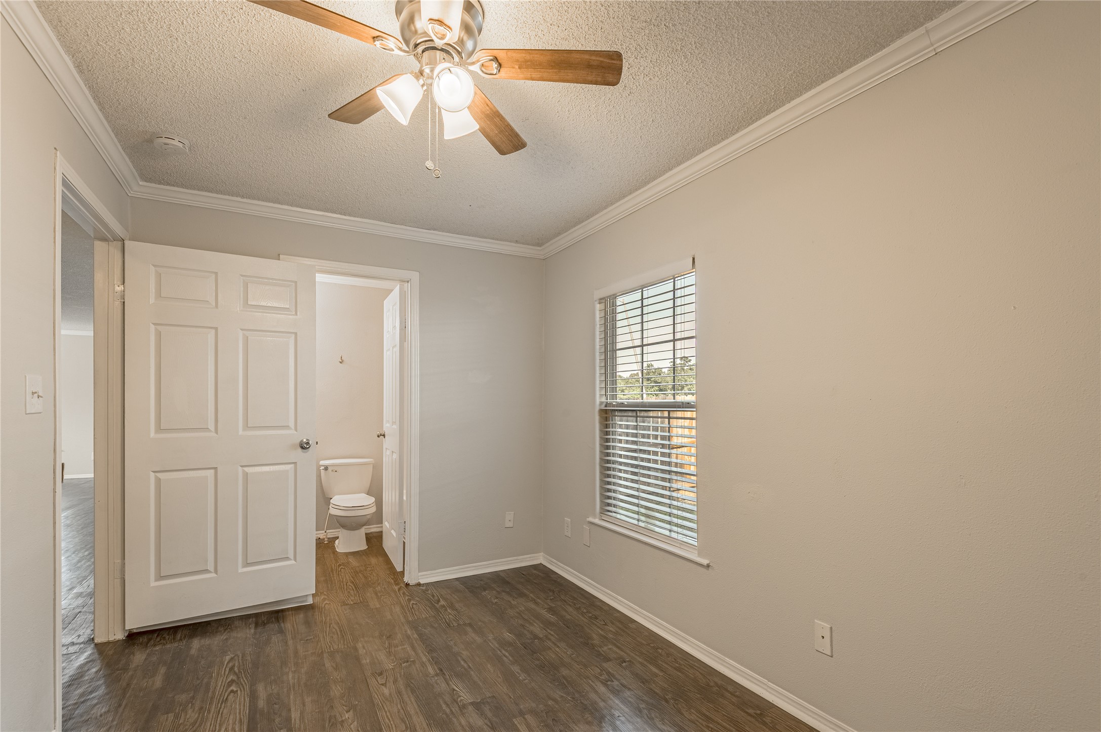 138 Varsity Circle Huntsville, TX 77340 - Photo 16 of 37 a view of an empty room with a window and wooden floor