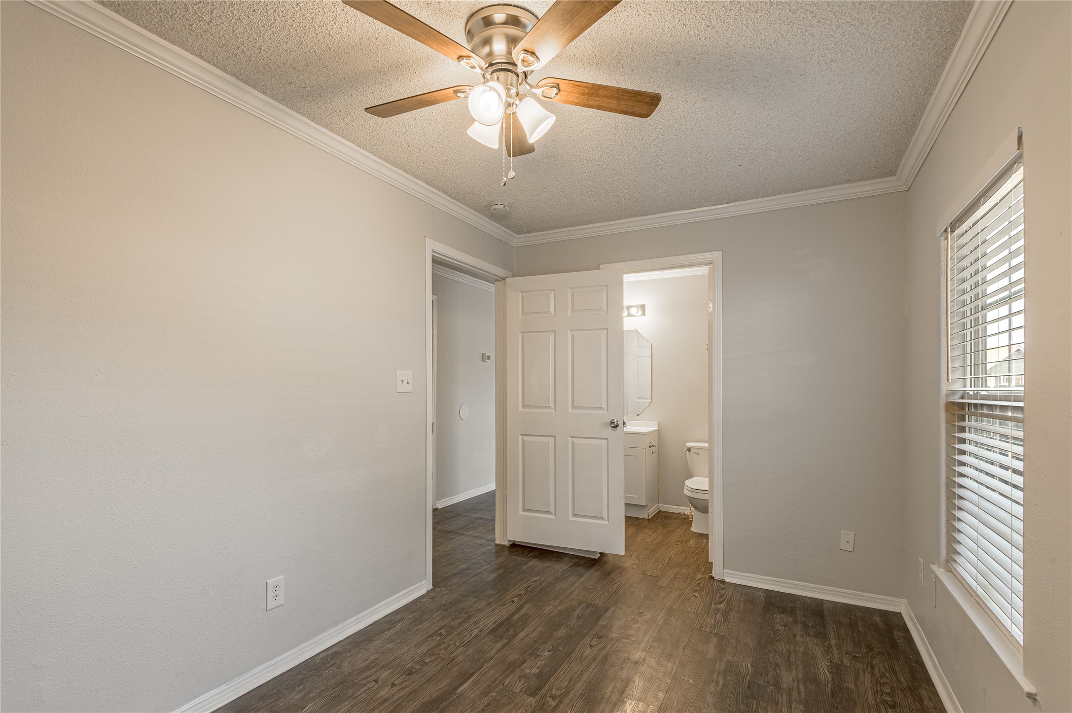 138 Varsity Circle Huntsville, TX 77340 - Photo 17 of 37 an empty room with wooden floor and windows