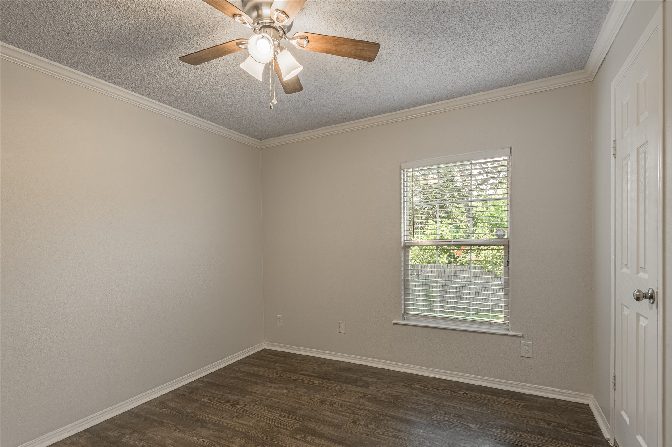 138 Varsity Circle Huntsville, TX 77340 - Photo 19 of 37 an empty room with a chandelier fan and windows