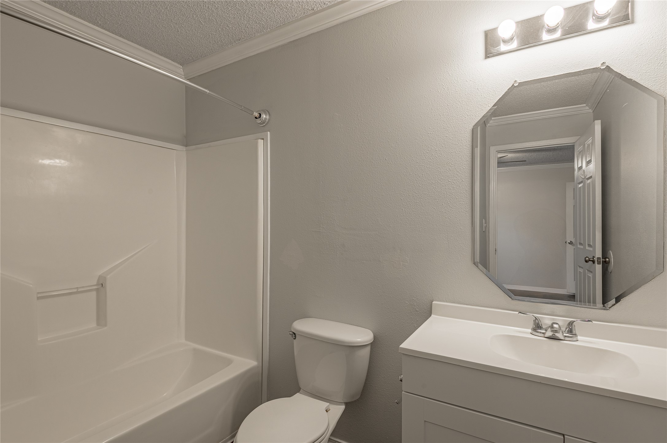 138 Varsity Circle Huntsville, TX 77340 - Photo 21 of 37 a bathroom with a toilet sink vanity and shower