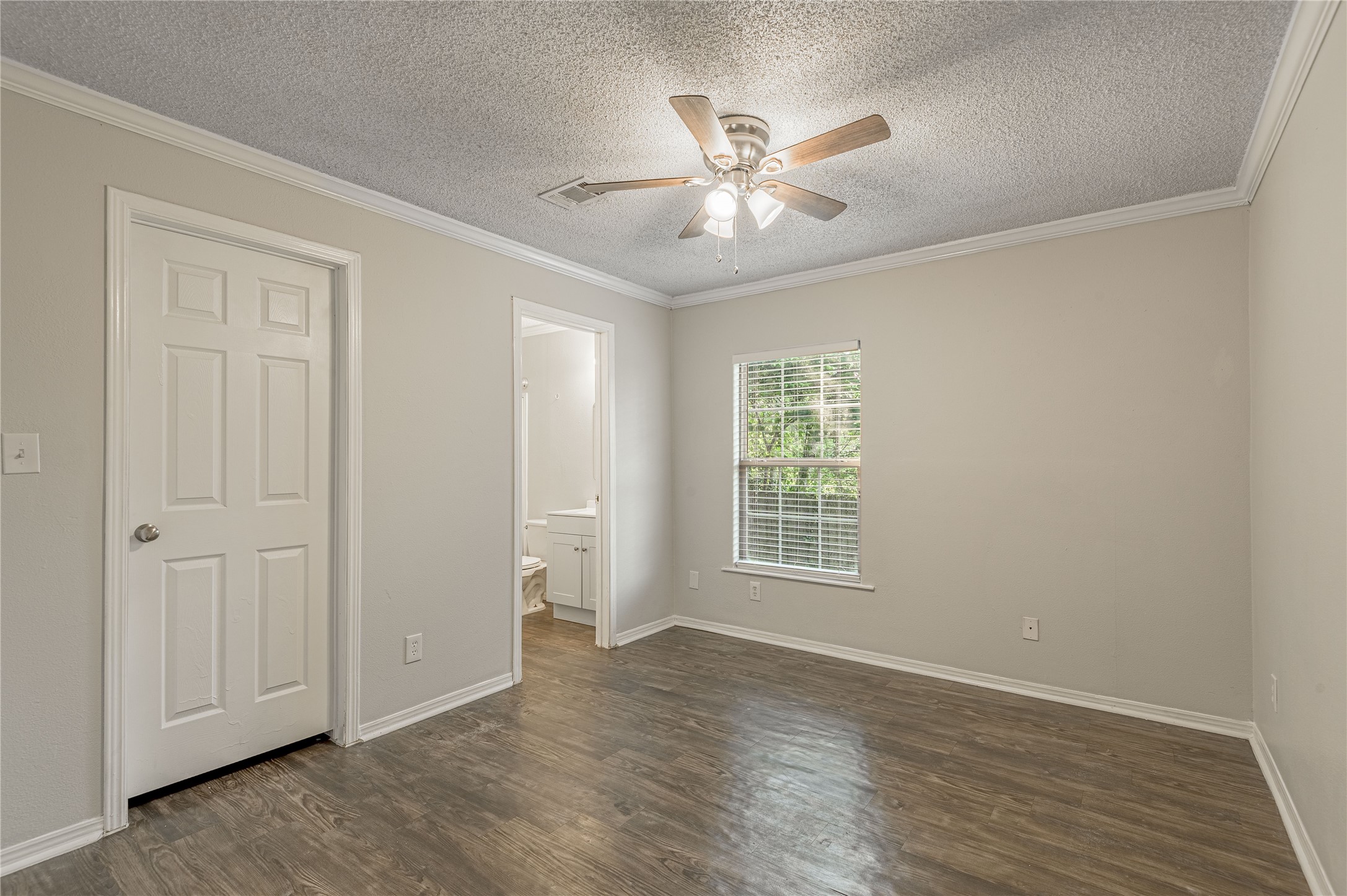 138 Varsity Circle Huntsville, TX 77340 - Photo 22 of 37 a view of an empty room with a window and wooden floor