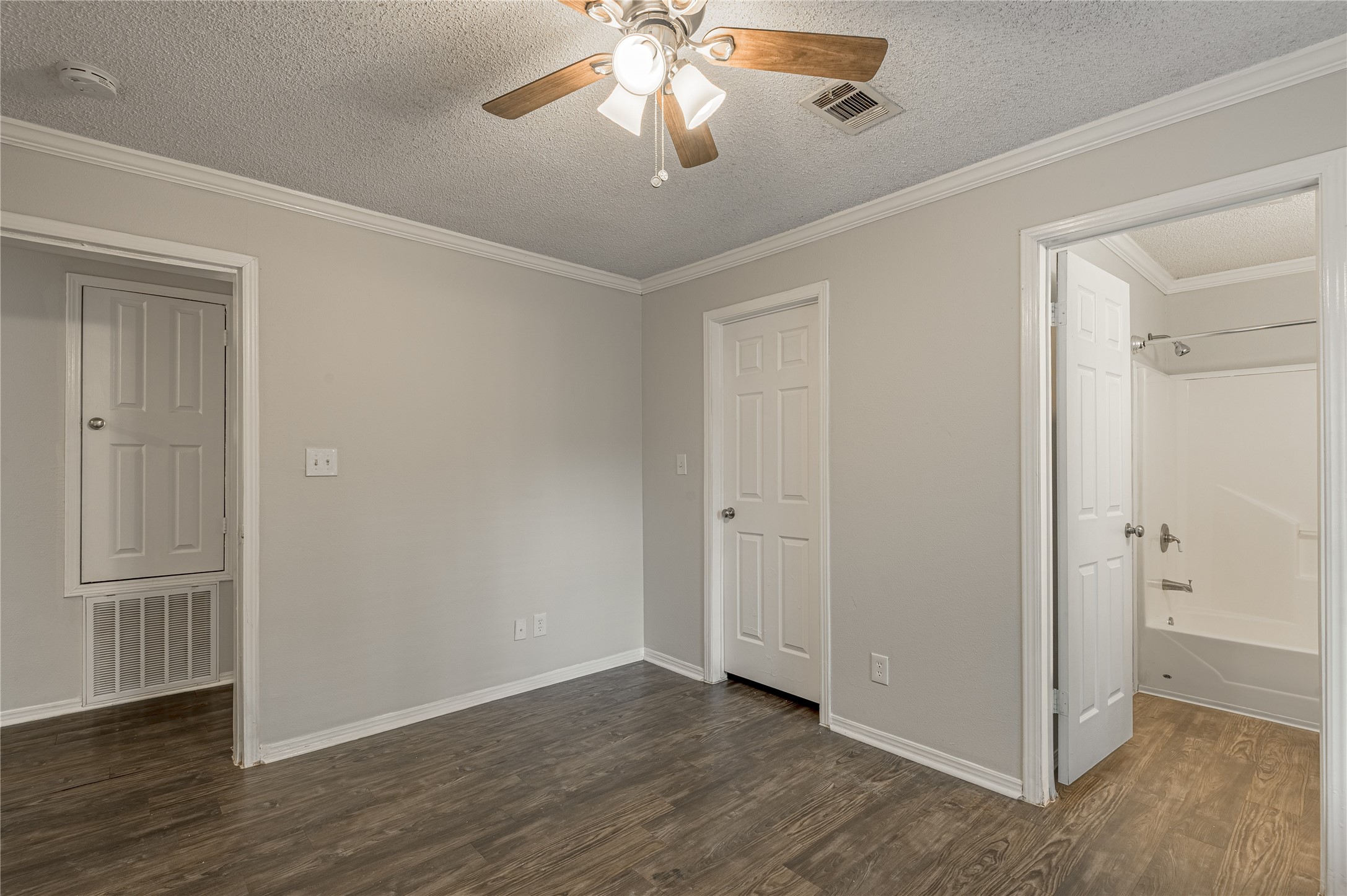 138 Varsity Circle Huntsville, TX 77340 - Photo 23 of 37 a view of empty room with wooden floor and fan