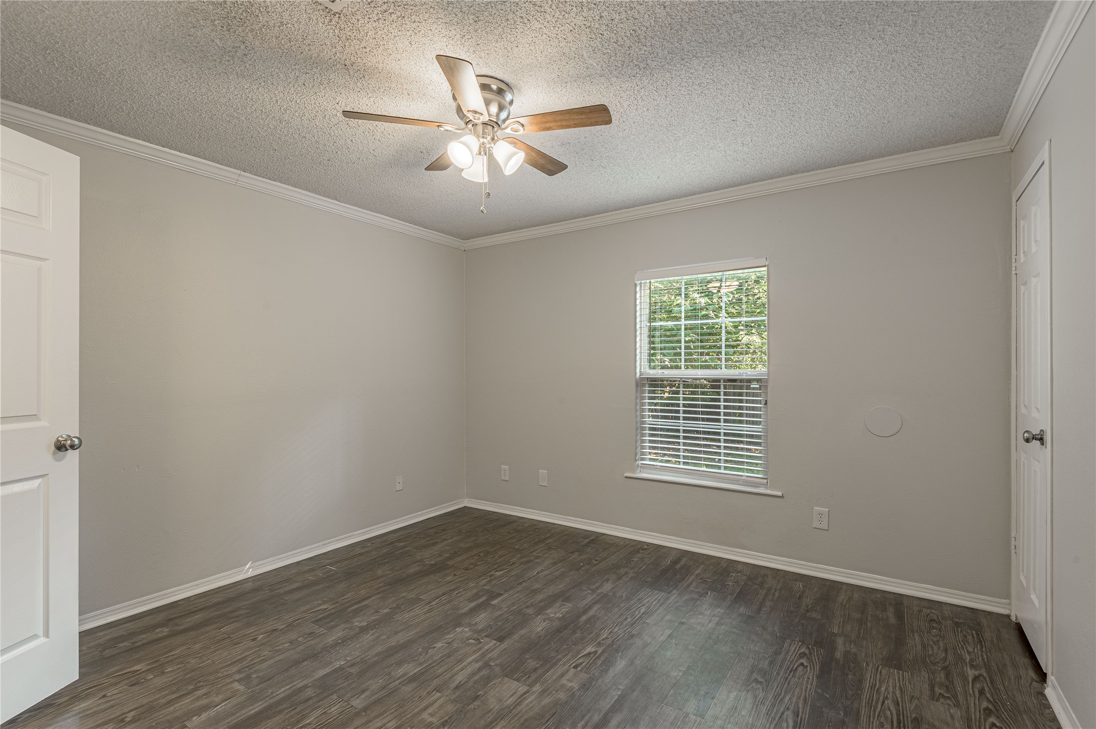138 Varsity Circle Huntsville, TX 77340 - Photo 27 of 37 a view of an empty room with wooden floor and a window