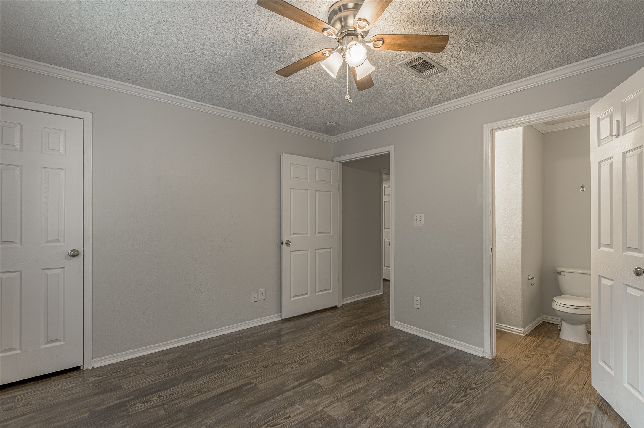 138 Varsity Circle Huntsville, TX 77340 - Photo 29 of 37 wooden floor in an empty room with a bathroom