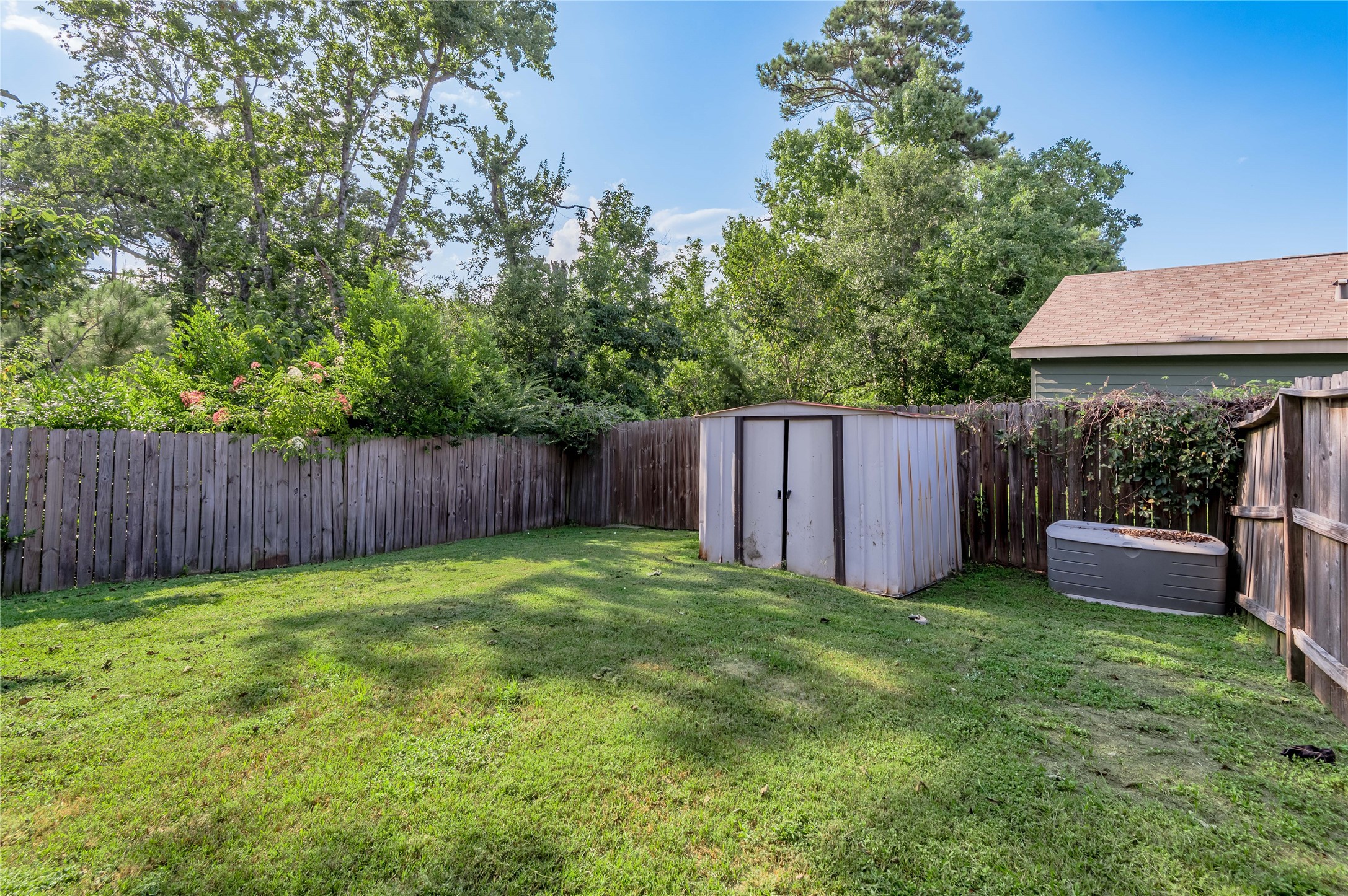 138 Varsity Circle Huntsville, TX 77340 - Photo 32 of 37 a view of a backyard with a garden and wooden fence