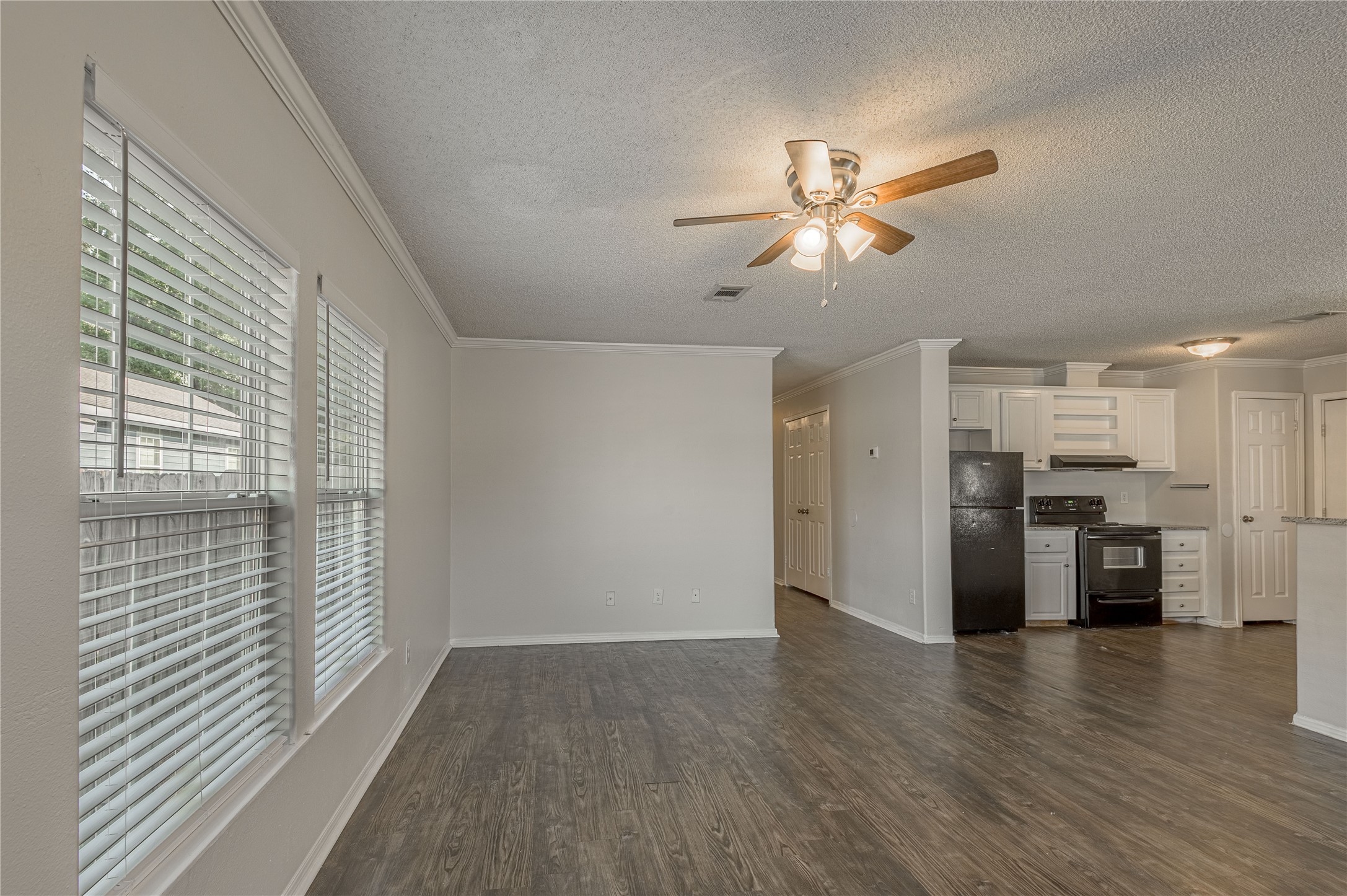 138 Varsity Circle Huntsville, TX 77340 - Photo 4 of 37 a view of empty room with wooden floor and fan