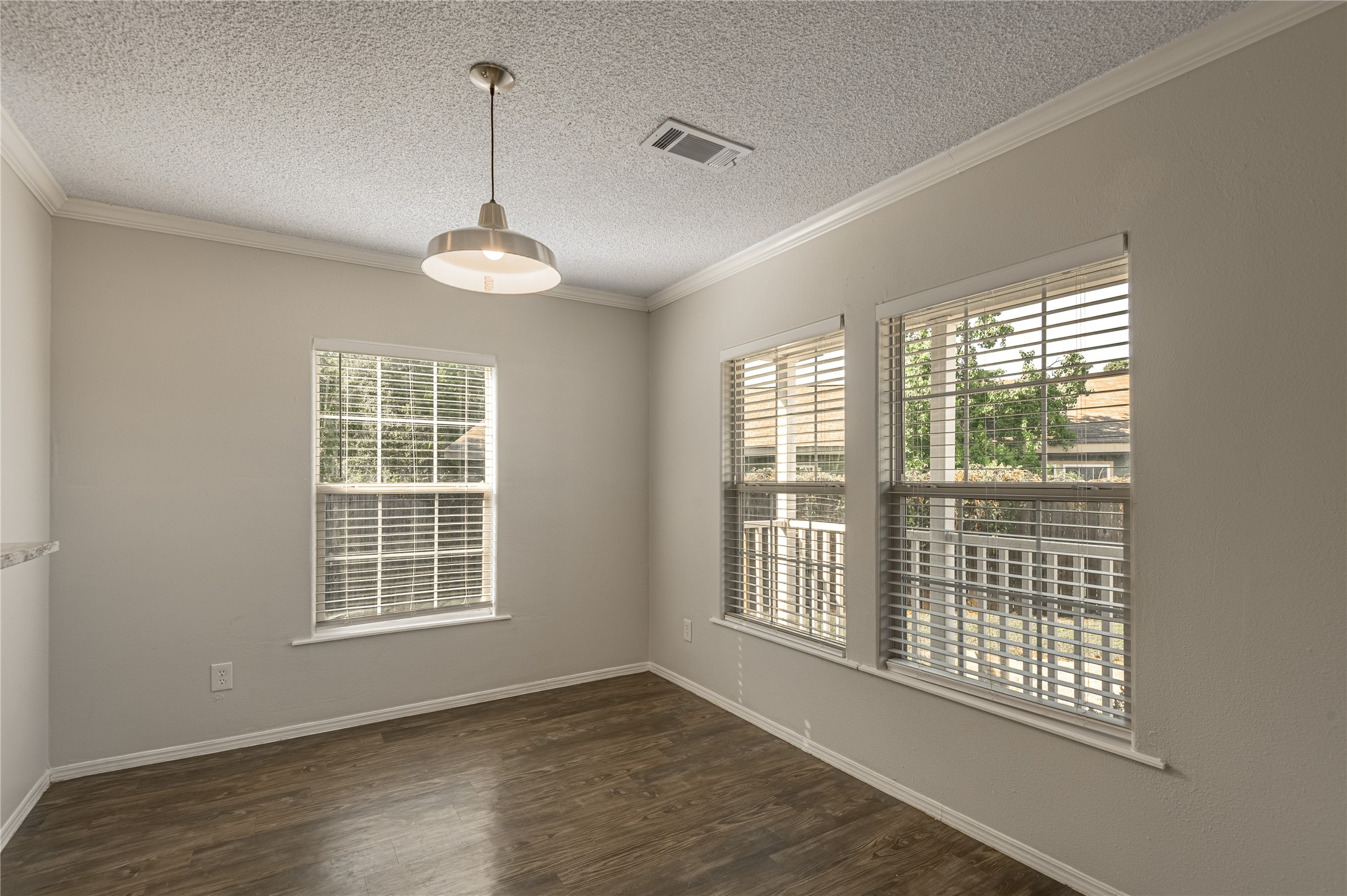 138 Varsity Circle Huntsville, TX 77340 - Photo 7 of 37 a view of an empty room with wooden floor and a window