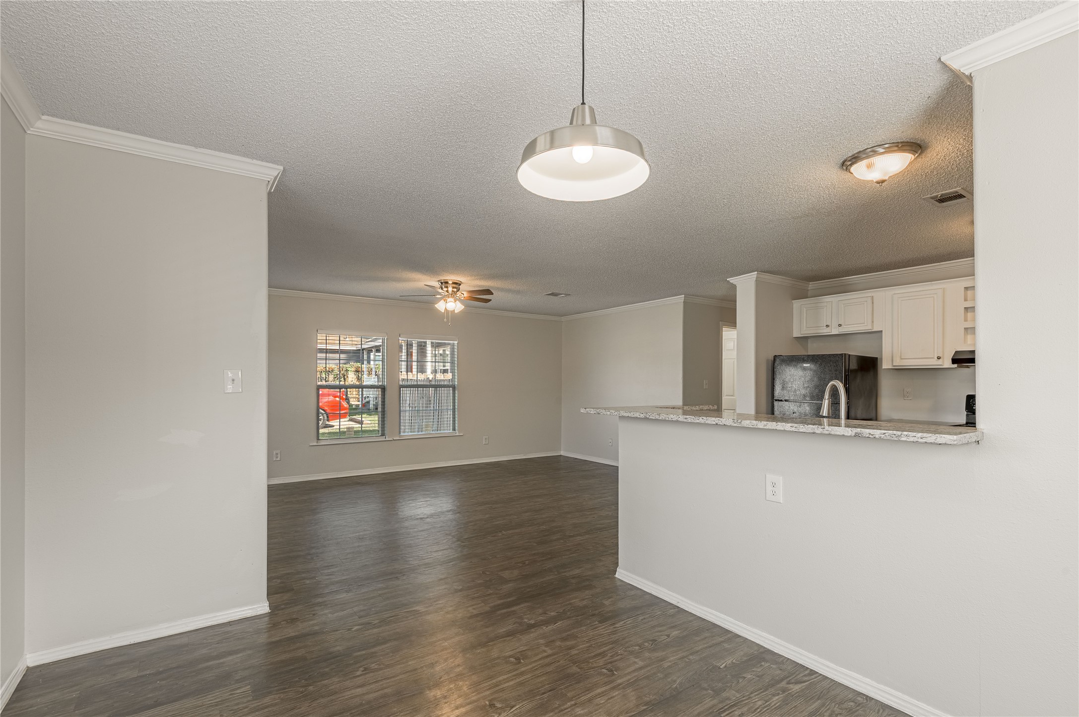 138 Varsity Circle Huntsville, TX 77340 - Photo 8 of 37 a view of a kitchen with a sink and dishwasher with wooden floor