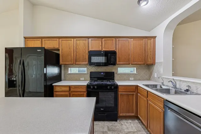 a kitchen with a sink a stove and refrigerator