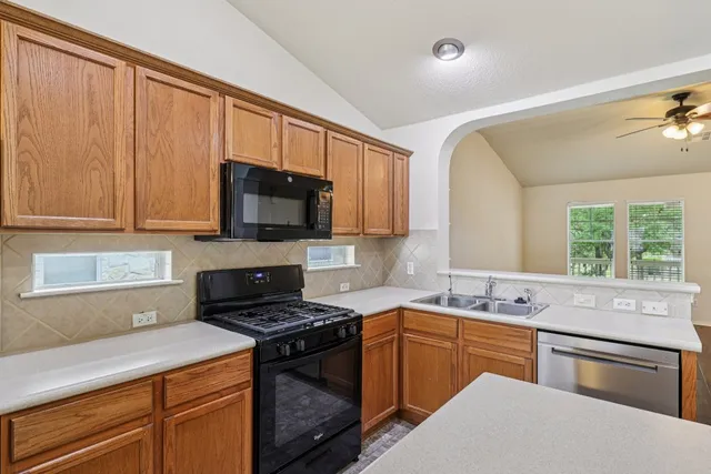 a kitchen with a sink stove and microwave
