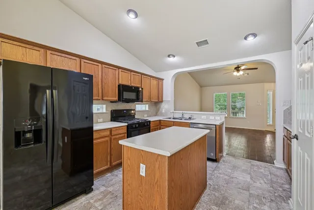 a kitchen with a refrigerator a stove top oven a sink and dishwasher