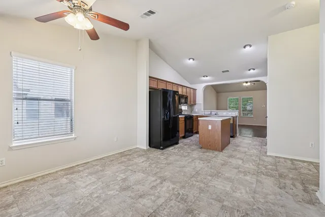 a kitchen with refrigerator and window