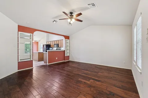 a view of a kitchen with a dishwasher cabinets and a large window