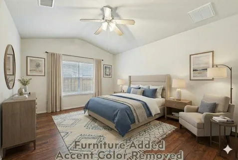 a spacious bedroom with a bed a couch and dresser