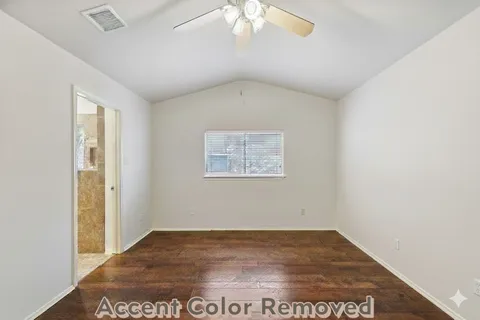an empty room with a ceiling fan and wooden floor