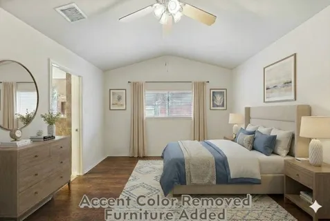 a bedroom with a large bed and a chandelier
