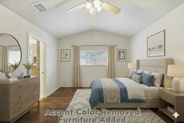 a bedroom with a large bed and a chandelier