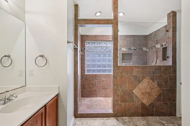 a bathroom with a shower and a sink