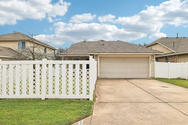 a view of a house with wooden fence