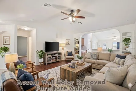 a living room with fireplace furniture and a flat screen tv