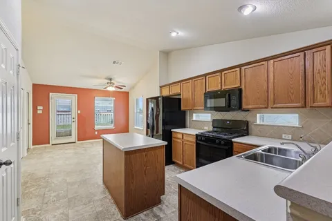 a kitchen that has a sink and a stove top oven