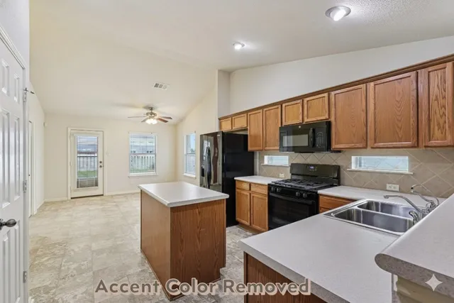 a kitchen that has a sink and a stove top oven
