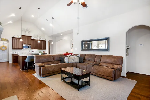 a living room with furniture a flat screen tv and a fireplace