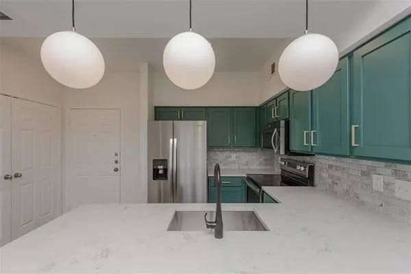 an empty room with a mirror and a wooden floor