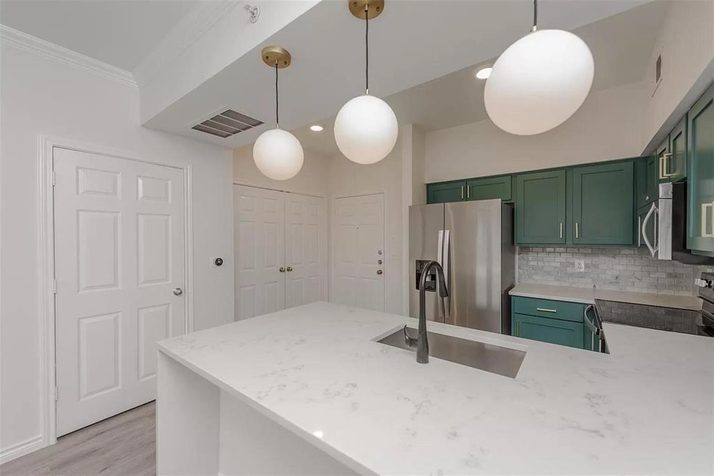 3102 Kings Road, Unit 2303 Dallas, TX 75219 - Photo 2 of 23 a view of a kitchen with a stove and cabinets