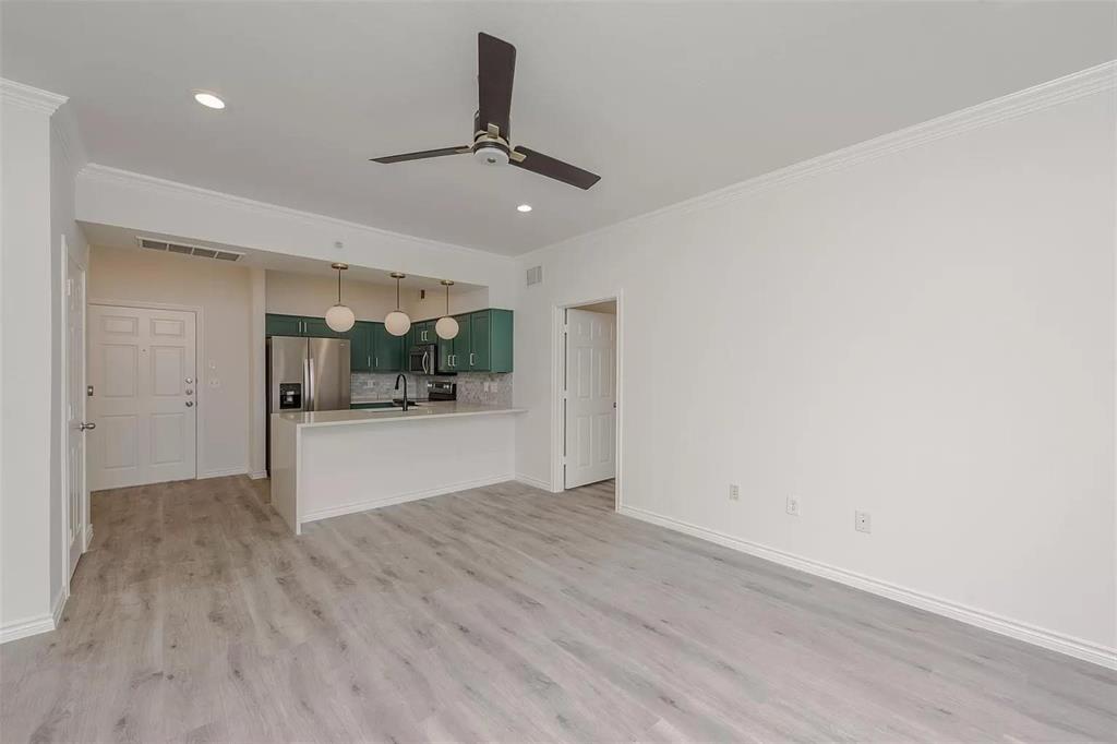 3102 Kings Road, Unit 2303 Dallas, TX 75219 - Photo 3 of 23 an empty room with wooden floor and windows