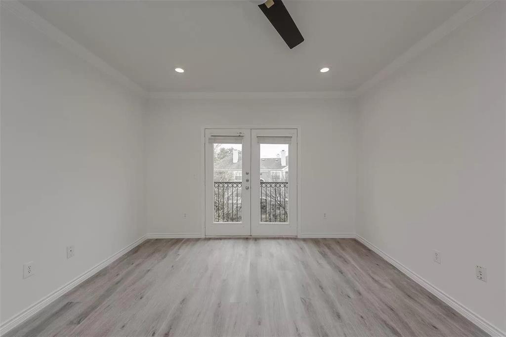 3102 Kings Road, Unit 2303 Dallas, TX 75219 - Photo 6 of 23 an empty room with wooden floor and windows