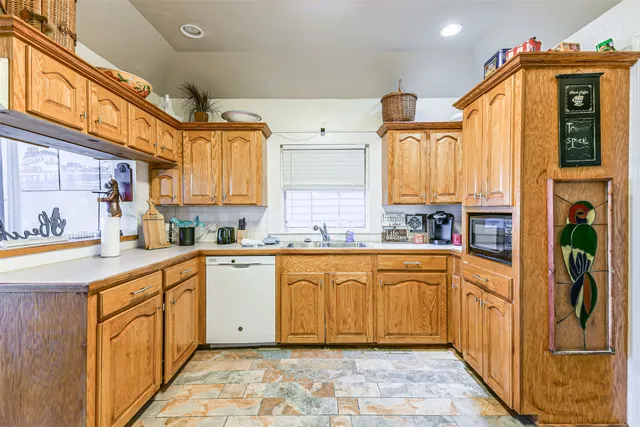 a kitchen with stainless steel appliances granite countertop a sink and cabinets